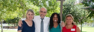 Communications faculty standing outside smiling